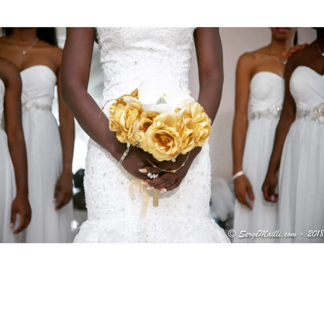 Bridal bouquet of gold roses from the white wedding ceremony
