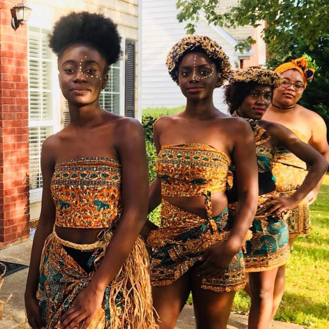 Bridal party in traditional attire with ceremonial face markings